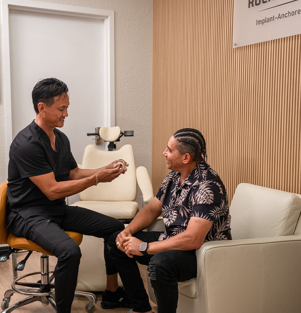 Dr. Aves showing a patient a full arch prosthesis